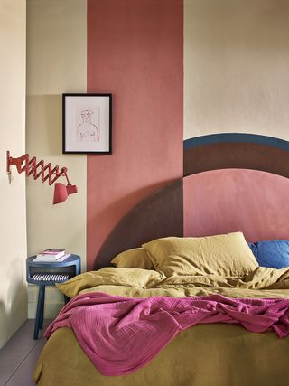 an eclectric and colorful bedroom with an unusual headboard display.Bedroom paint ideas