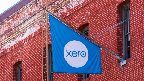Flag outside a redbrick building with the Xero logo