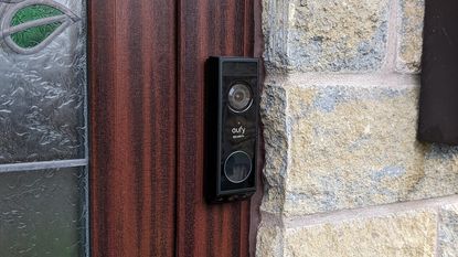 Eufy E340 Video Doorbell outside a door