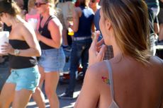 Photo of a woman with a tattoo on her shoulder, facing away from the camera