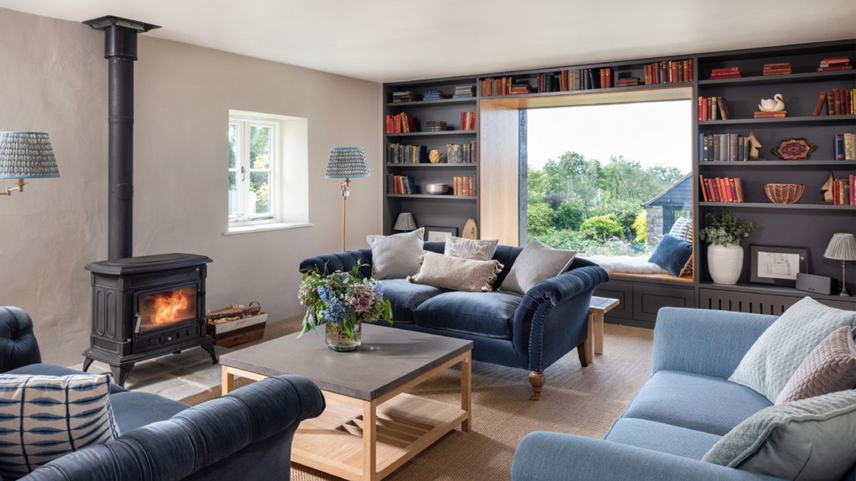 a living room with a picture window with a view over a landscape