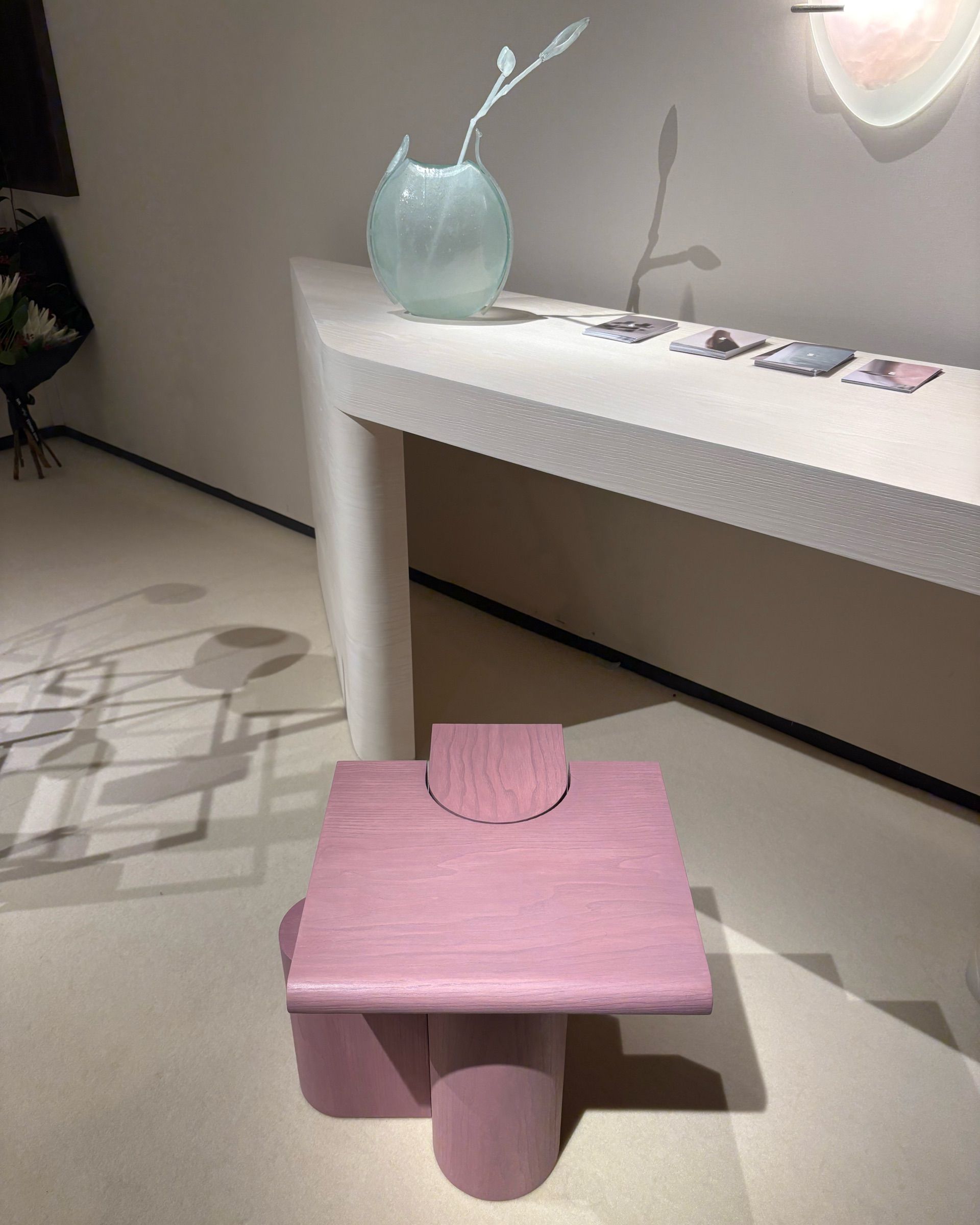 A series of contemporary furniture items with either a stitched-up or a tetris-looking structure sits in a warmly lit gallery space.