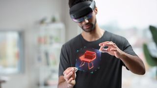 Someone using HoloLens 2 to manipulate a model of a chair