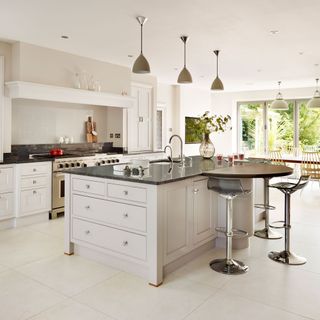 shaker style kitchen in smart neutral shades with granite-topped counter island