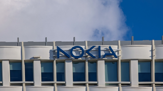 A large blue Nokia logo is mounted on the white facade of the Nokia corporate office building in Munich, Bavaria, Germany, on January 7, 2026.