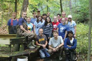 Green Lake High School students work on a tributary of Green Lake. 