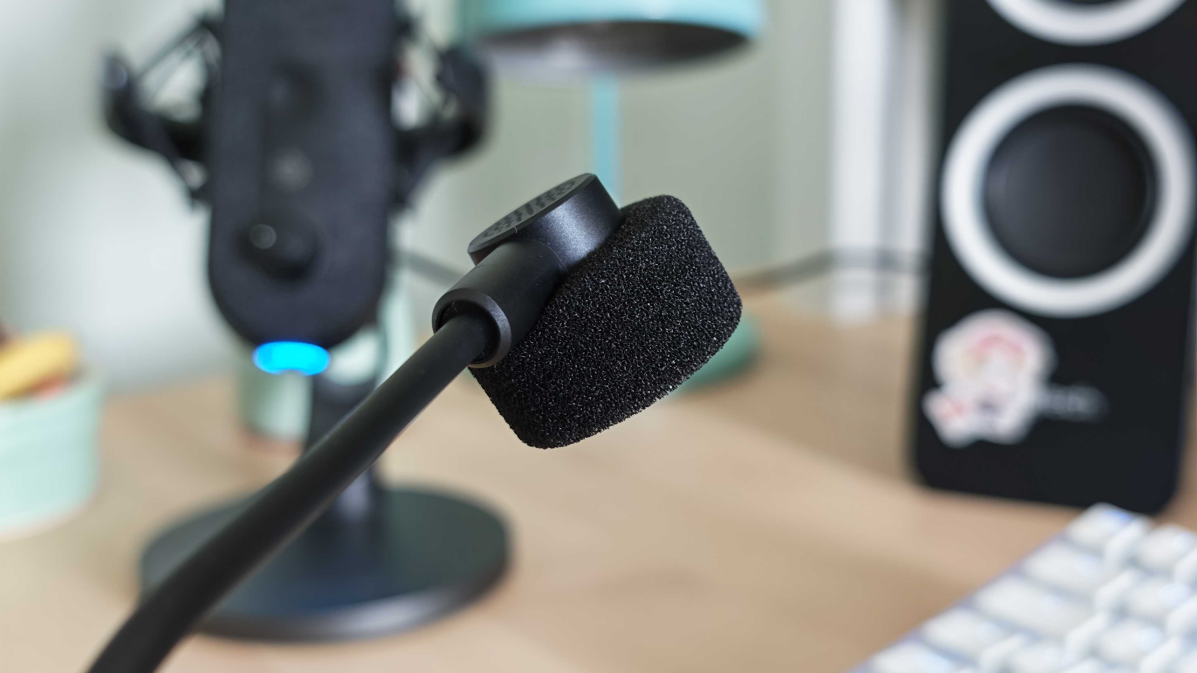 A photo of the Inzone H6 Air gaming headset positioned above a wooden desktop surface.