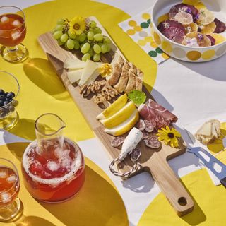 A table with a charcuterie board and drinks
