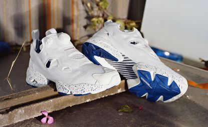 white and blue Reebok shoes