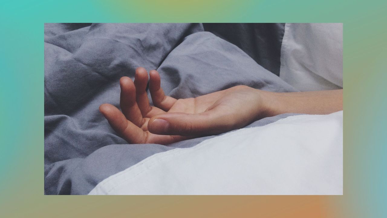 Cropped Hand Of Man Sleeping On Bed - stock photo