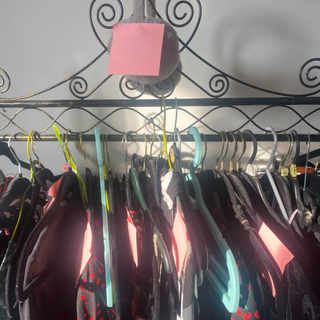 Clothes rail with pink Post-it's attached