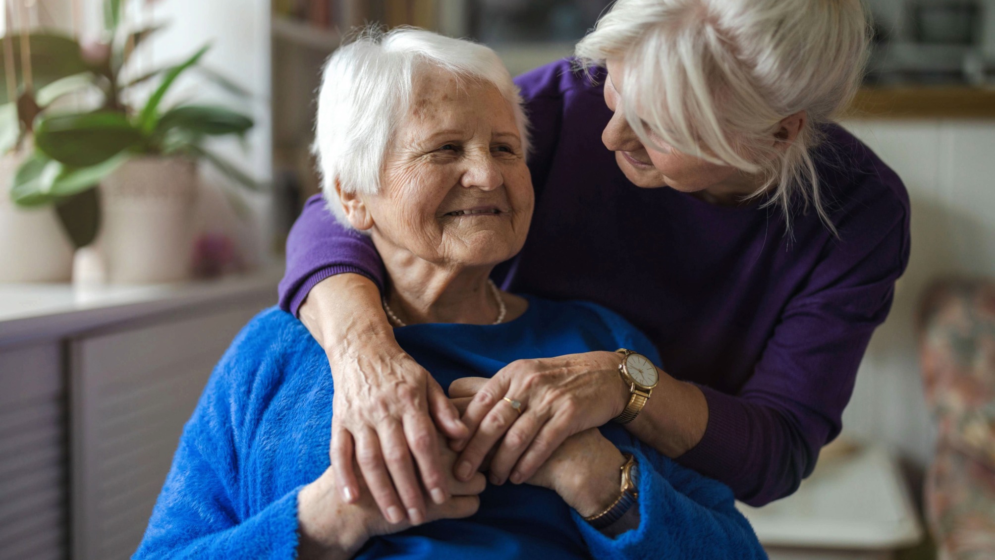 Woman hugging her elderly mother