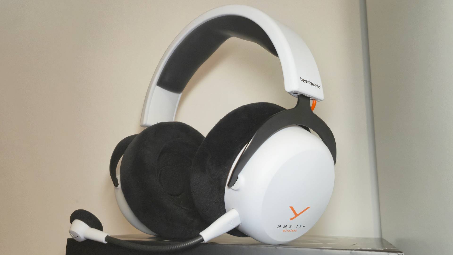 Photo of the MMX 150 Wireless headset sitting on its box.