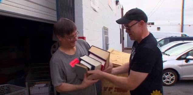 A man drops off books at The Book Thing.