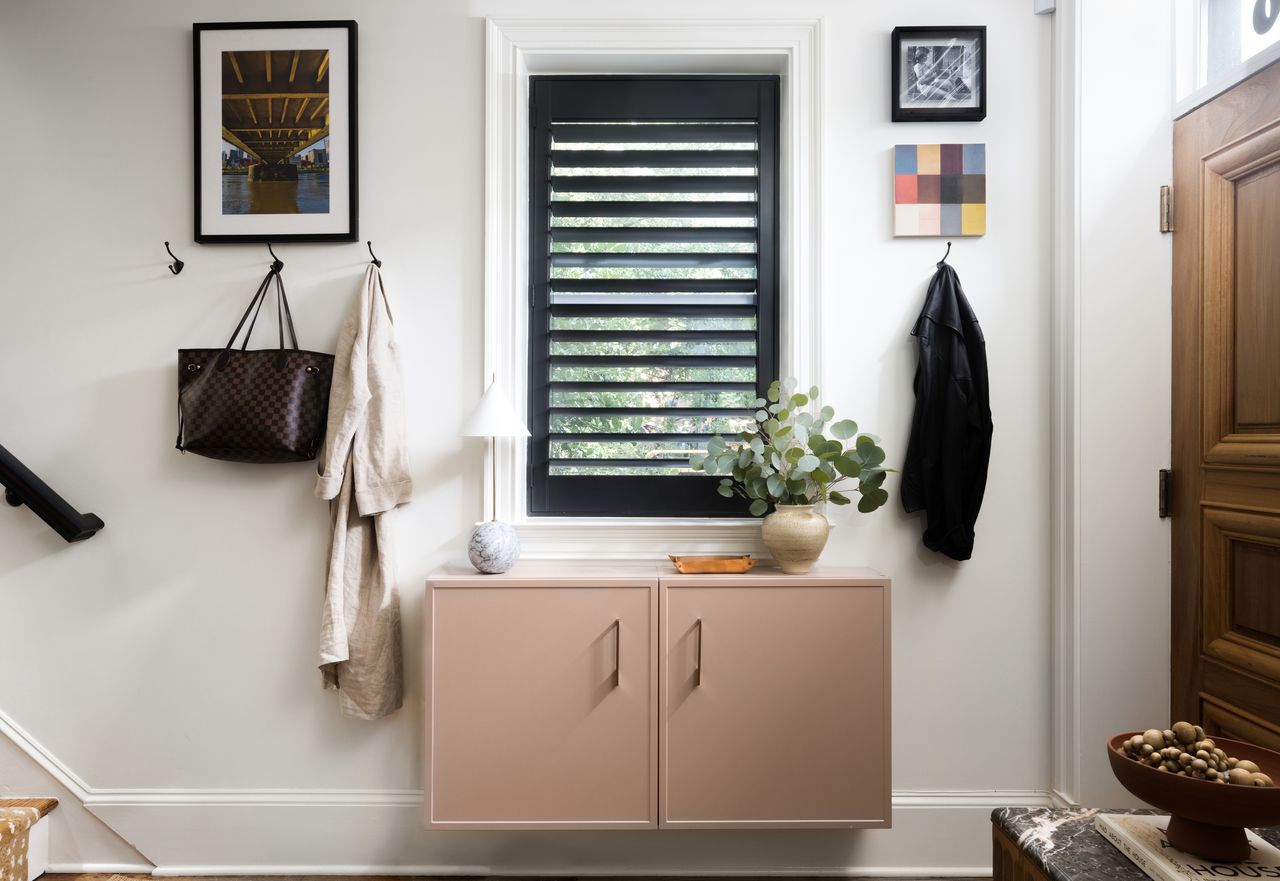 The entryway with a pink painted cupboard