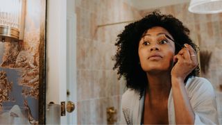 woman applying makeup