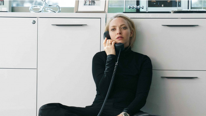 Amanda Seyfried as Elizabeth Holmes sat on the floor whilst on the phone