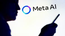 Meta AI logo and branding pictured on a wall with silhouette of man holding up smartphone in foreground.