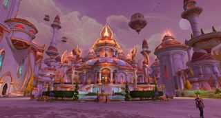 A screenshot of the World of Warcraft: Midnight alpha. A wide shot of Silvermoon City, the golden elven city. A beaming building sits in the middle, surrounded by bushes and a glowing pool.