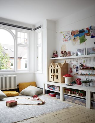 A kids playroom with a pegboard installed on the wall for storage