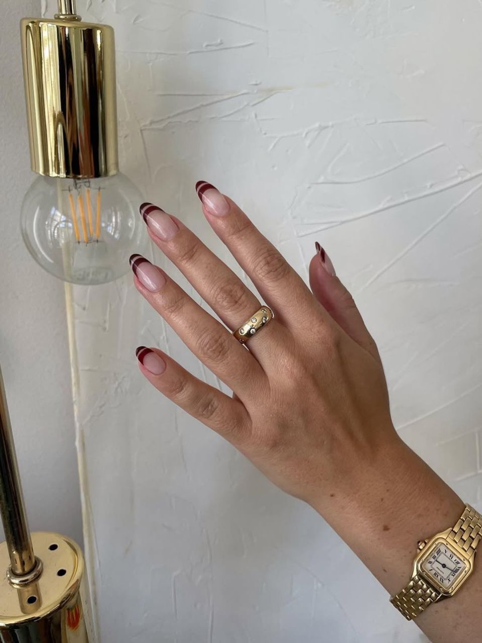 An image featuring a burgundy nail design, courtesy of @saruhnails