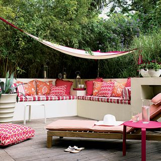 garden seating with canopy and pink cushions