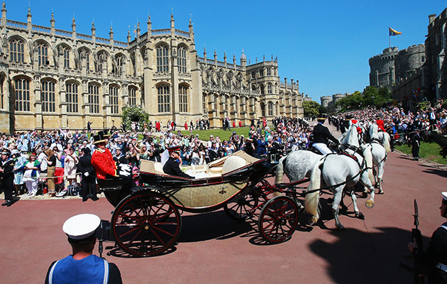 WINDSOR, ENGLAND - MAY 19: Prince Harry, Duke of Sussex and the Duchess of Sussex in the Ascot Landau carriage during the procession after getting married St George's Chapel, Windsor Castle on May 19, 2018 in Windsor, England. (Photo by Chris Jackson/Getty Images)