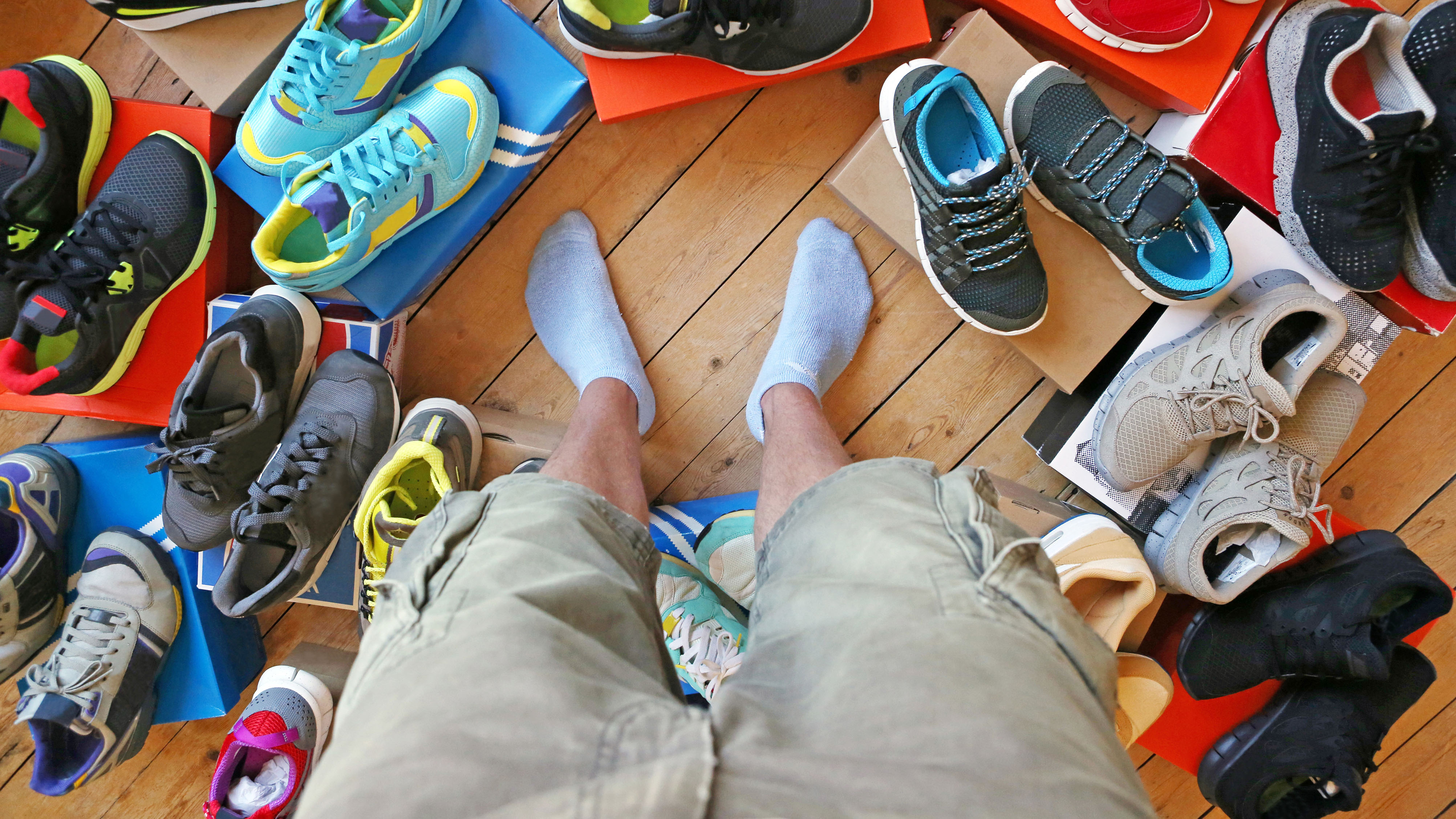 Man surrounded by running footwear