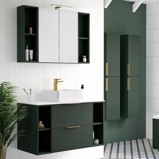 Green fitted bathroom furniture including wall cabinet and wall-mounted vanity with white wall tiles