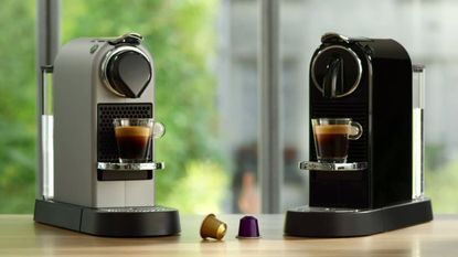 Two Nespresso Citiz espresso coffee maker machines on wooden worktop