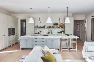 Grey kitchen island base cabinets with marble countertop and splashback