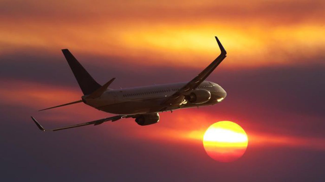 Plane flying into sun