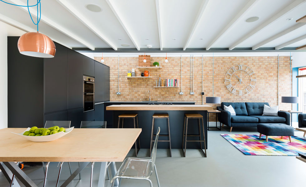 industrial style open plan black kitchen in modern home