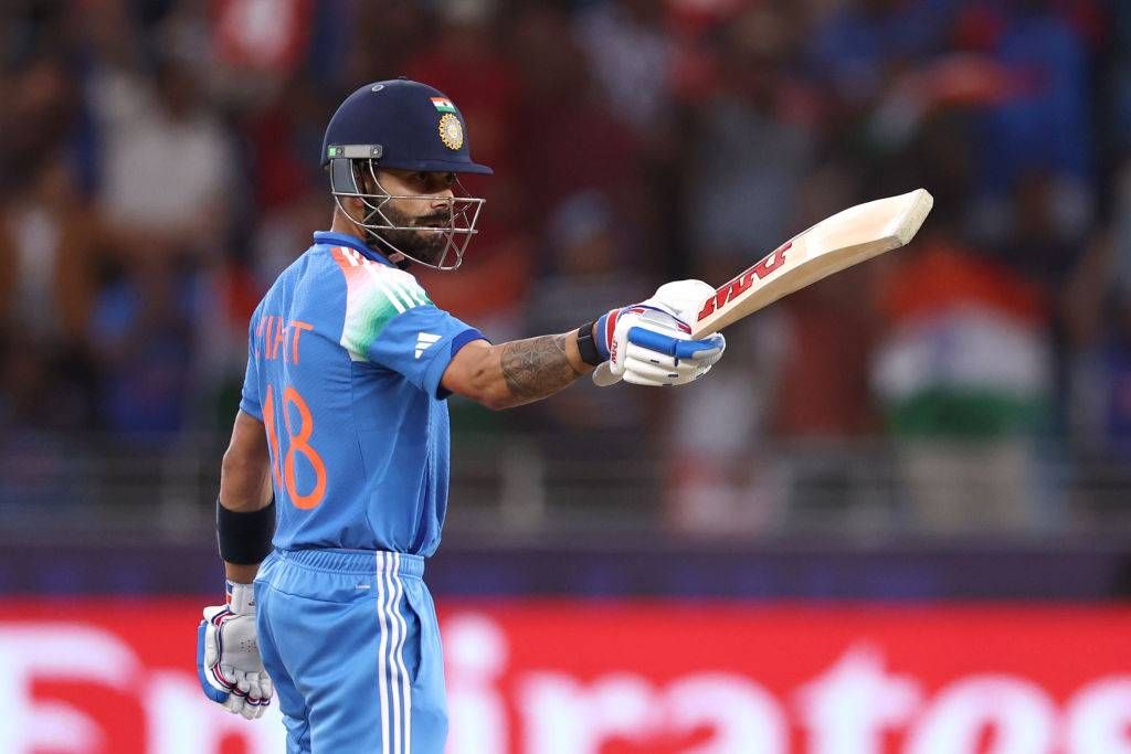 Virat Kohli of India salutes the crowd after reaching his half century during the ICC Champions Trophy 2025 semi final between India and Australia at Dubai International Cricket Stadium