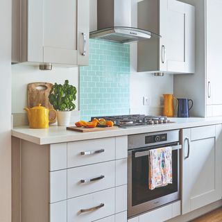 white kitchen with aqua blue splashback tiles