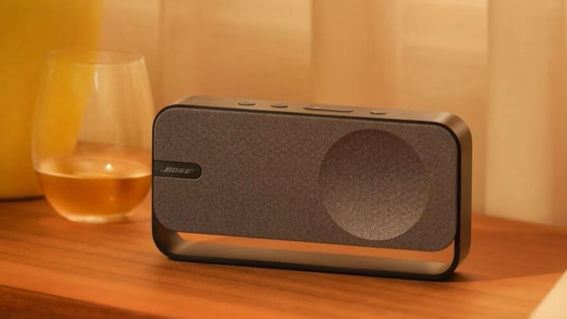 Bose SoundLink Home in grey on a wooden surface