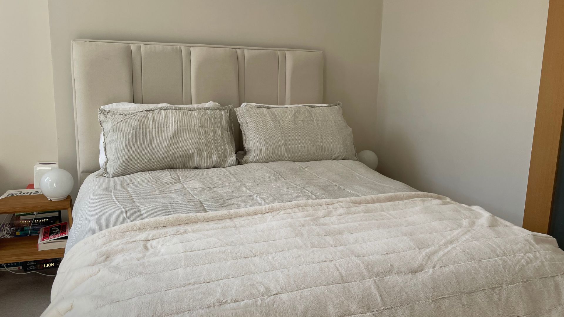 Secret Linen Store Natural Sid Stripe Linen on the bed with a throw