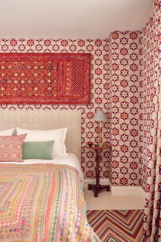 spare bedroom with vibrant red patterned wallpaper