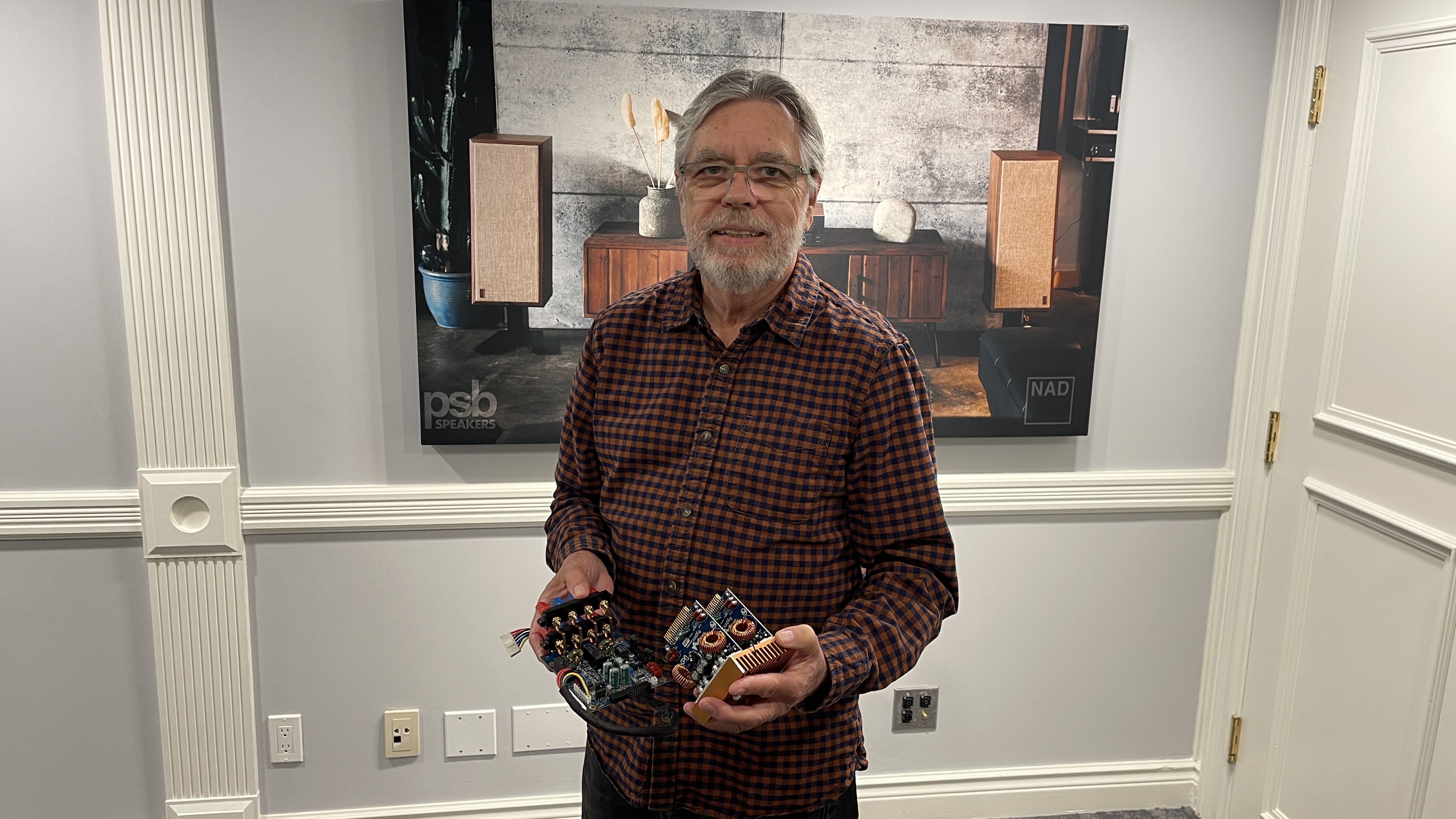 Lenbrook CTO Greg Stidsen holds a pair of Class D power modules