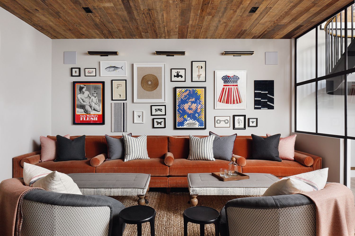 living room with red sofa, two coffee tables and a gallery art wall