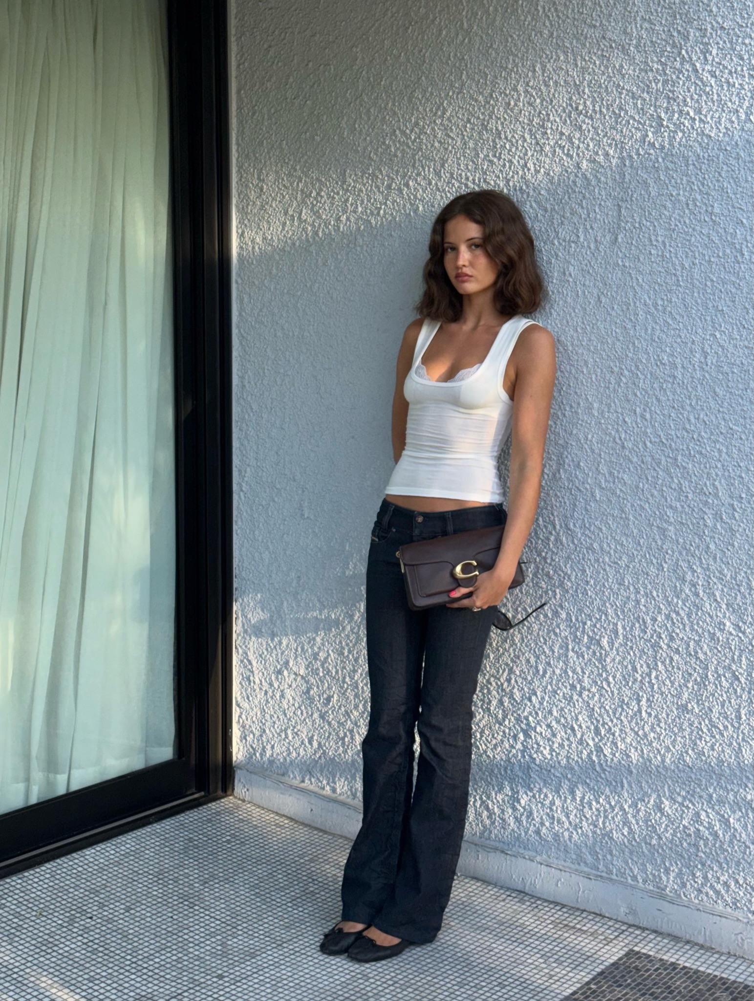 Ruby Lyn wearing lingerie-inspired top with low-rise jeans.