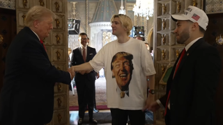 Donald Trump shakes hands with streamer xQc, wearing a custom Trump t-shirt in which the ex-president is wearing a grill on his teeth. Adin Ross looks on.