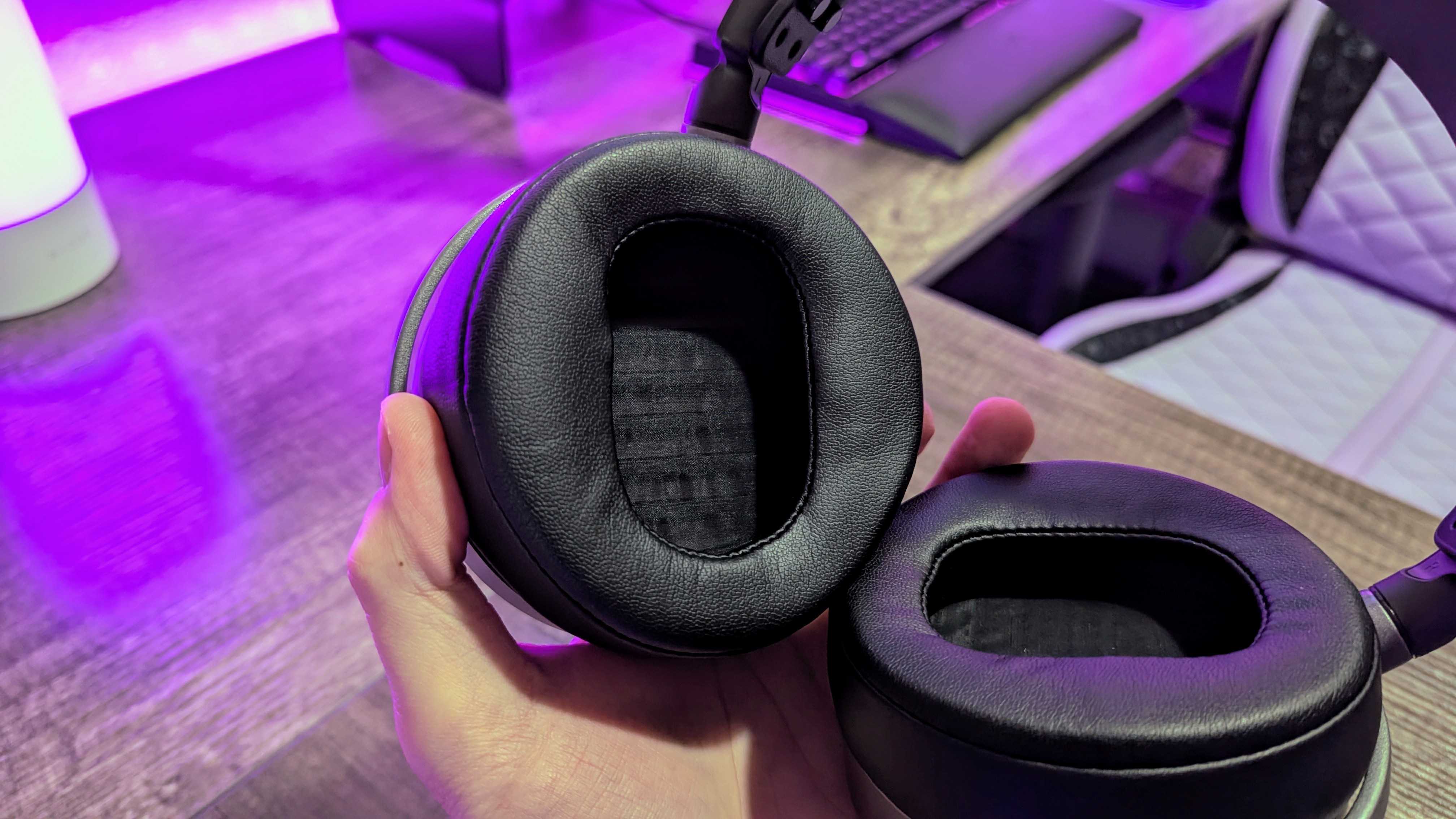 The Audeze MM-100 held in a hand, showing the inside of one earcup.