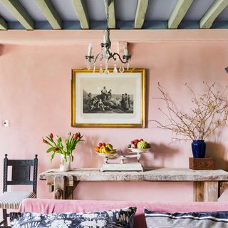 living room with pink wall and wooden beams
