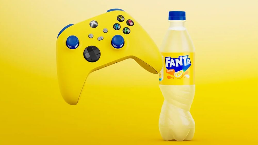 A bright yellow Fanta-branded Xbox controller and a bottle of Fanta