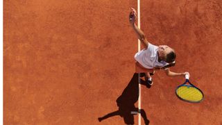 Woman serving and playing tennis