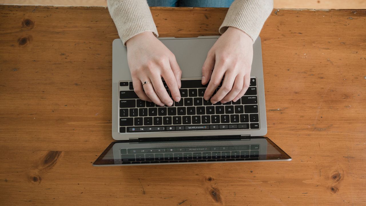 Person typing computer keyboard