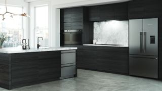 modern kitchen with black units showing double drawer stainless steel fronted dishwashers in kitchen island with sink