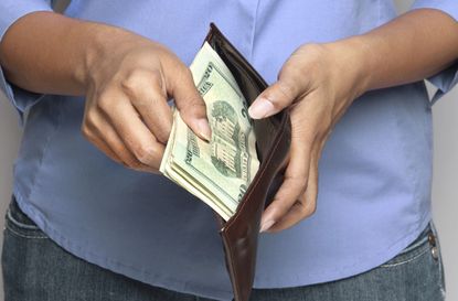 Person holding wallet with money