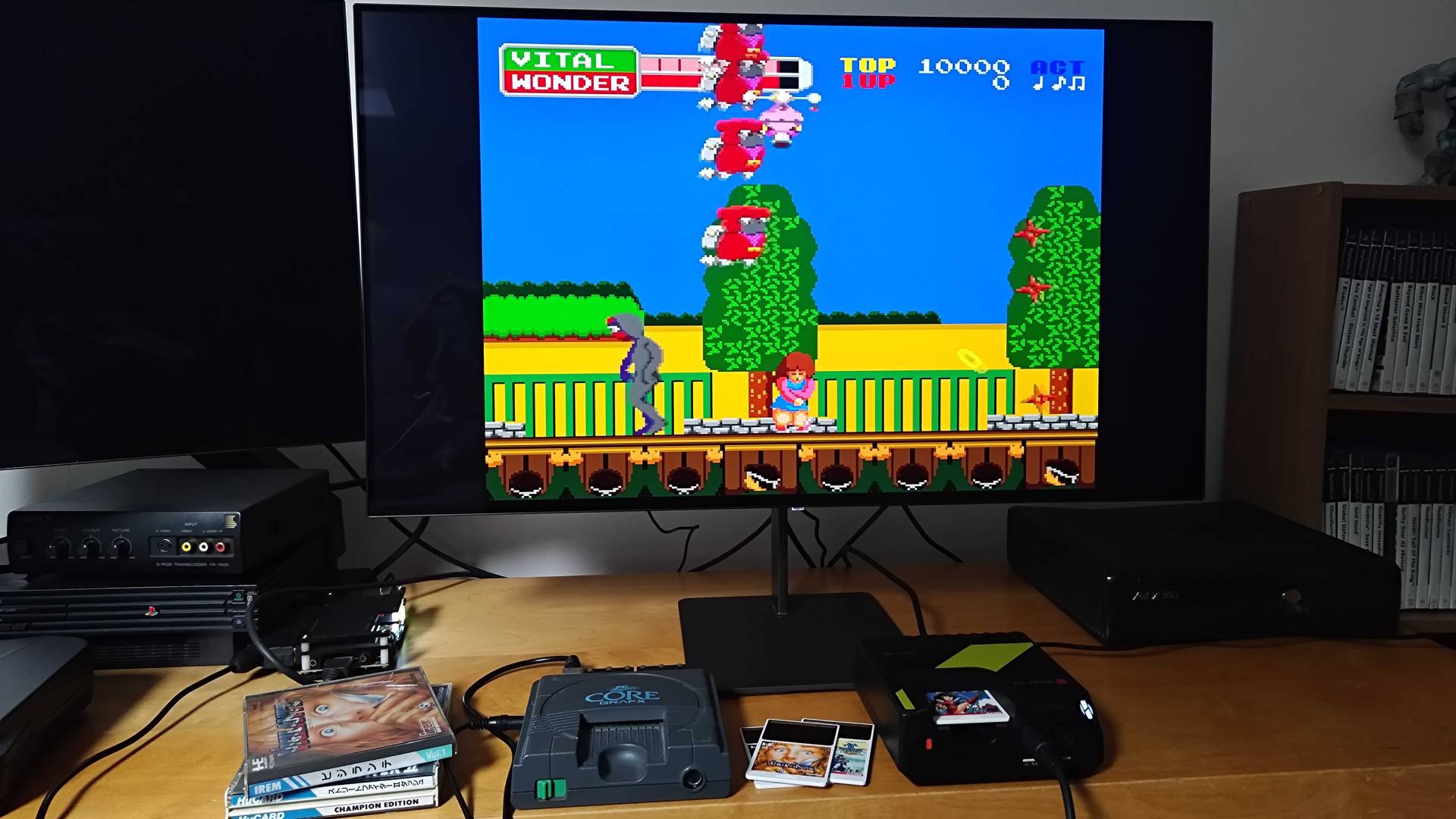 Hyperkin Retron GX running Wonder Momo next to PC Engine beneath monitor.